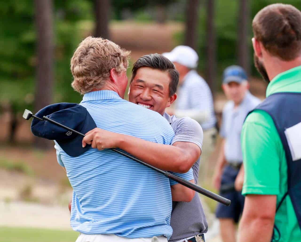 Ben Wong hugs teammate Frankie Capan after Wong made the clinching birdie putt on the 17th green of Pinehurst No. 2 to capture the 3rd U.S. Amateur Four-Ball Championship on Wednesday. (Copyright: USGA/Chris Keane)