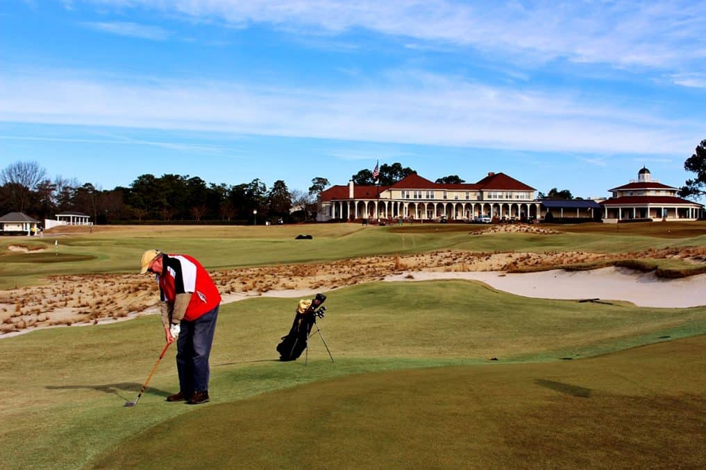 Ray Elliott takes a practice swing with his father’s niblick on the 3rd hole of The Cradle.