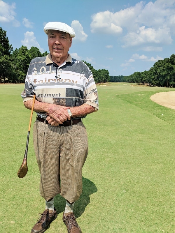 Palmer Maples Jr., 86, stands near the first tee of Pinehurst No. 2 holding a club made by Old Tom Morris, given to Maples’ father by Donald Ross.