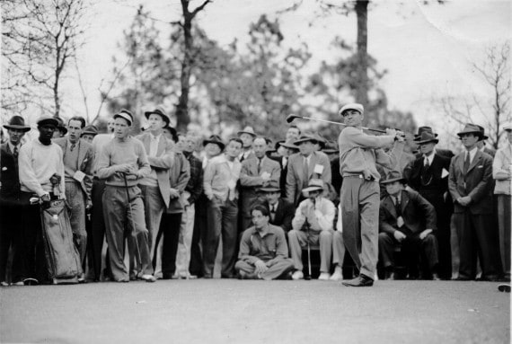 Willie McRae, far left, watches as Ben Hogan tees off during the 1951 Ryder Cup at Pinehurst.