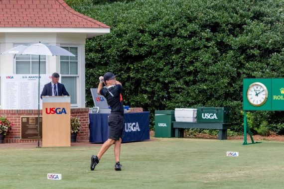 tees off the first hole of Pinehurst No. 2 during his Round of 64 match at the U.S. Amateur on Wednesday. (Photo by John Gessner)