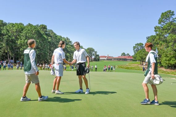 North & South Amateur Champion Louis Dobbelaar (left) shakes hands with runner-up Jackson Van Paris on the first green of Pinehurst No, 2 after Dobbelaar prevailed in 19 holes. (Photo by John Patota)