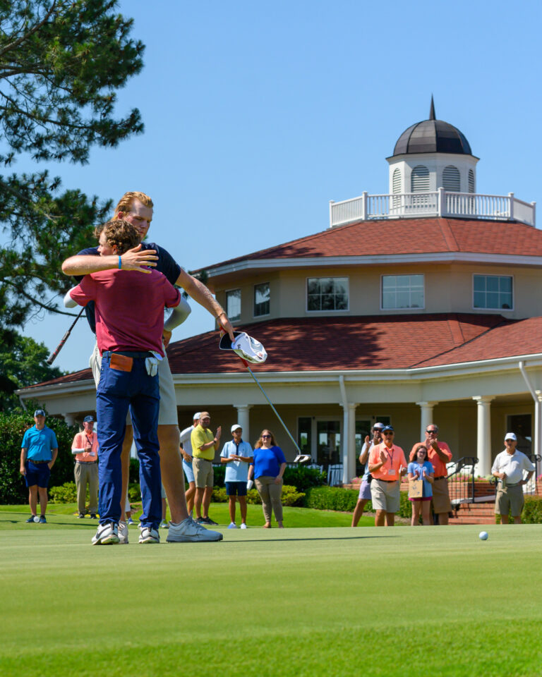 North & South Amateur Champion Luke Clanton (in red) hugs his opponent Tommy Morrison after Morrison conceded on Pinehurst No. 2 on Sunday. (Photo by John Patota)