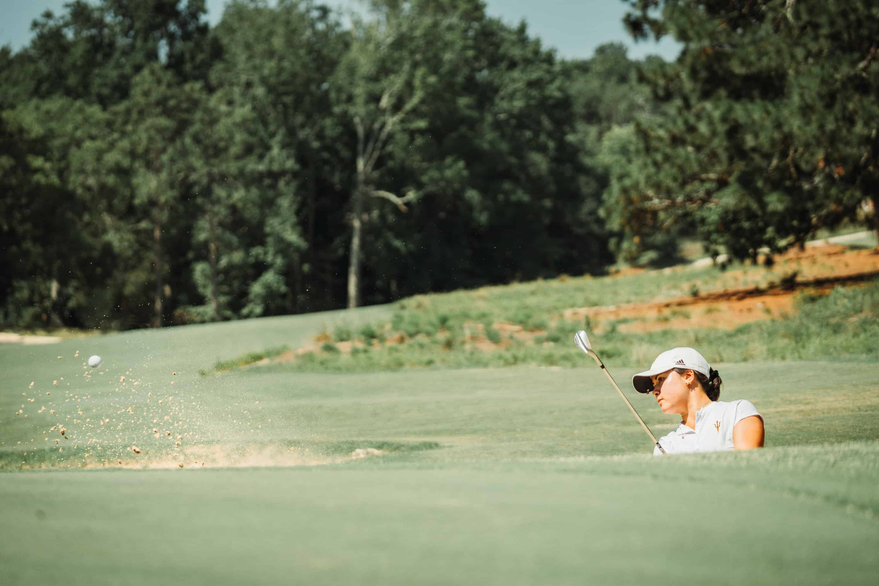 Ashley Menne blasts out of a greenside bunker on Wednesday. (Photo by Zach Pessagno)