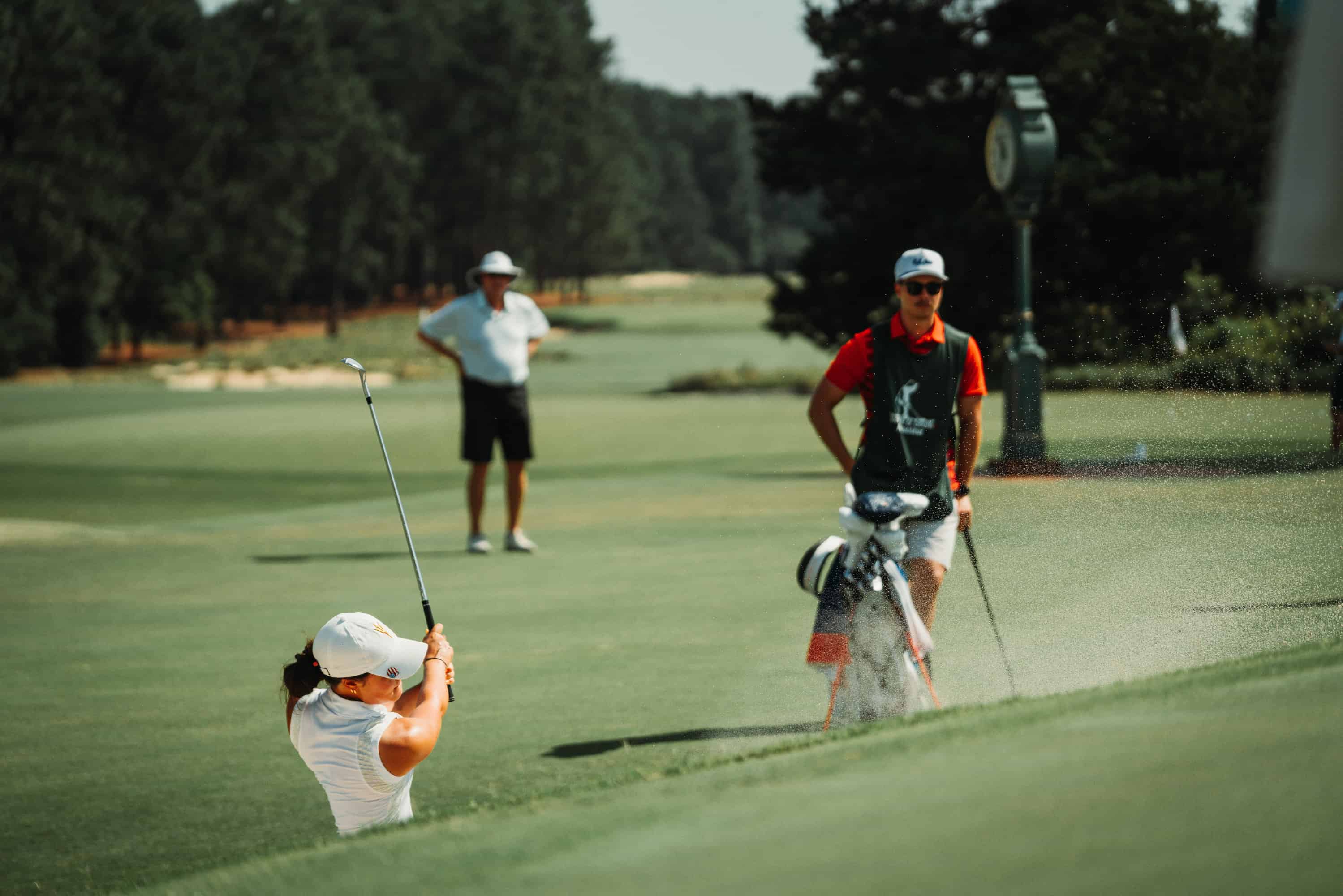 Ashley Menne plays from the bunker right of the 18th green on Pinehurst No. 2. (Photo by Zach Pessagno)