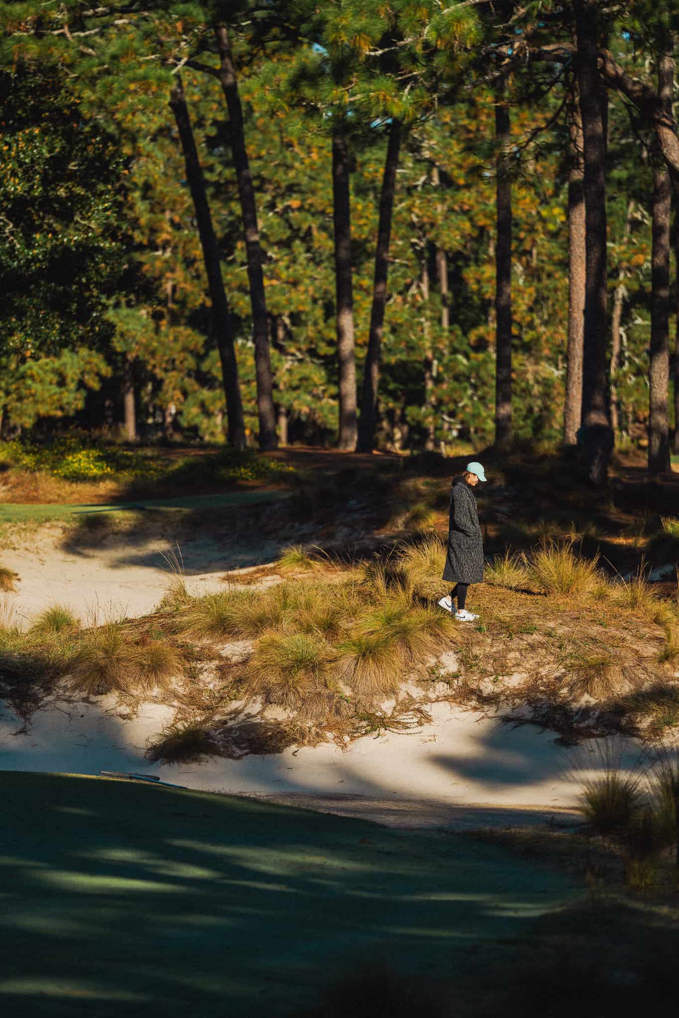 Michelle Wie West walks through the area where she nearly lost a ball on the 16th hole of Pinehurst No. 2 during the final round of the U.S. Women's Open in 2014.