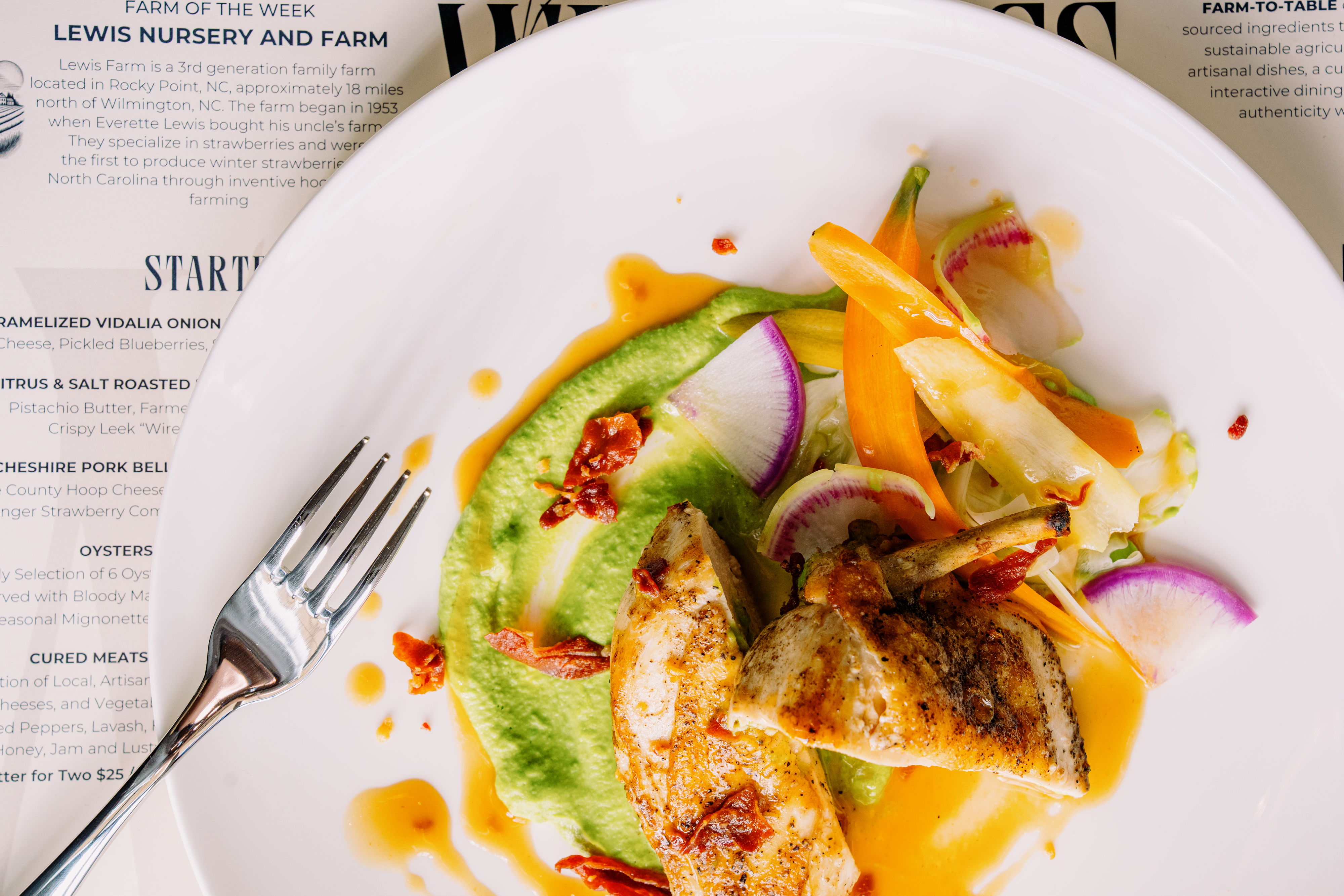 The thyme-roasted Joyce Farms chicken supreme is served with minted pea purée, leeks and crispy country ham.